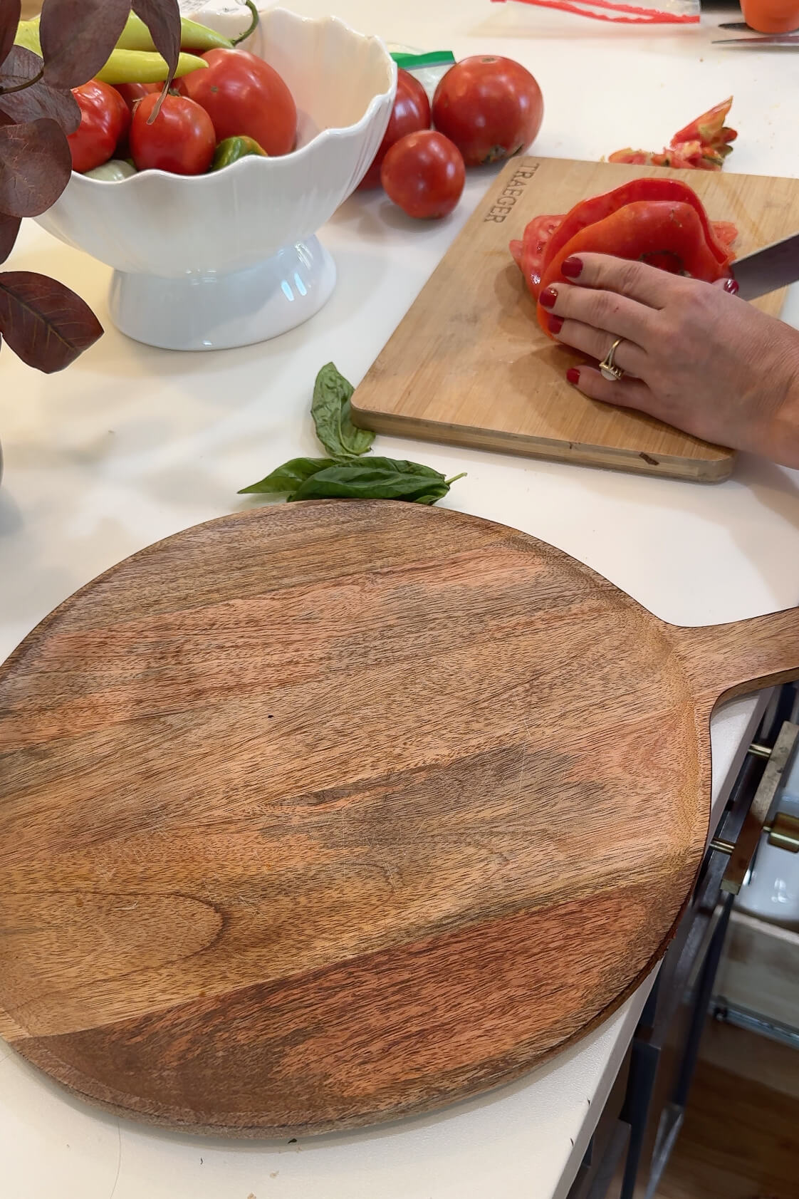 Assembling Caprese salad on a charcuterie board.